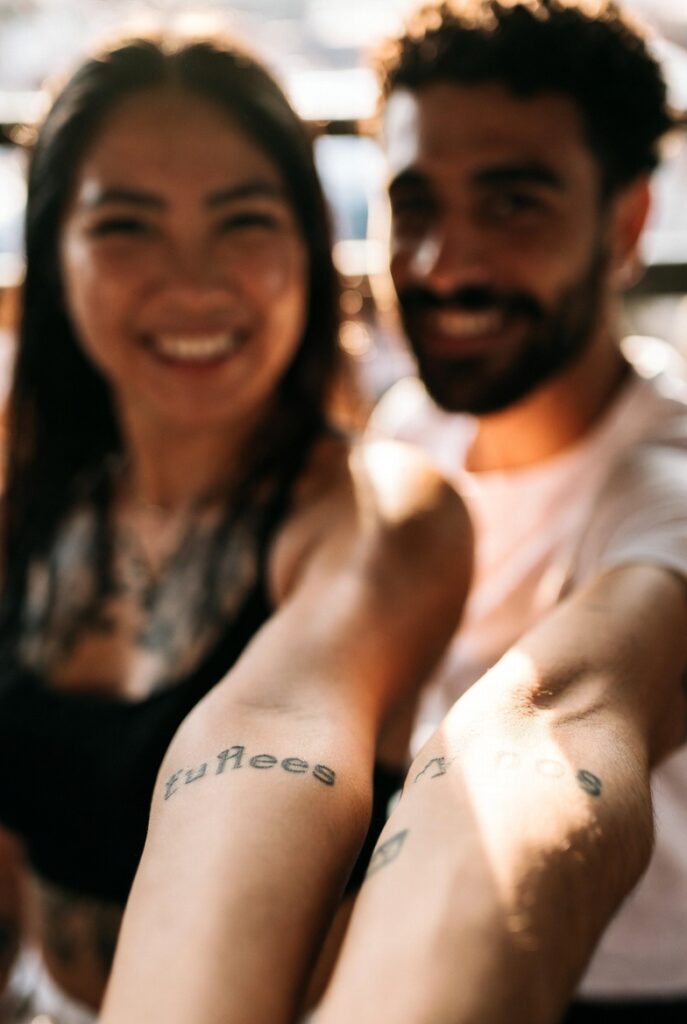 Two best friends showing matching phoenix tattoos, representing meaningful best friend tattoo ideas that symbolize an unbreakable bond