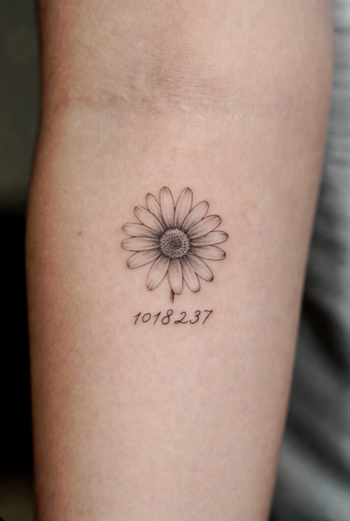 Vertical Daisy Spine Tattoo